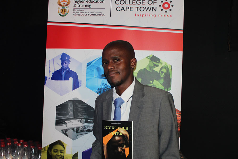 web-Mandilakhe-Pato-with-his-book-Ndixolele-Peter-during-his-book-launch